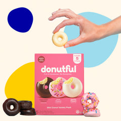 A hand reaching into a Variety Box and picking out a vanilla donut.