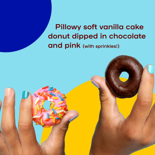 One hand holding a pink dipped donut and another holding a chocolate dipped donut.
